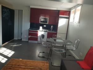 a kitchen with a table and chairs in a room at WindRose 0 in Madrid