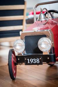 a red toy fire truck sitting on a wooden floor at Henriëtta in Hoboken