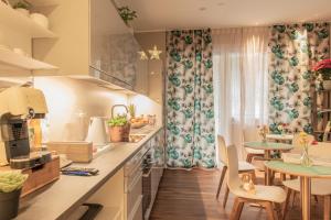 a kitchen with a table and chairs and a dining room at B&B H68 in Alassio