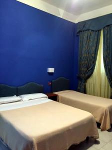 Postel nebo postele na pokoji v ubytování Hotel Altavilla Dieci