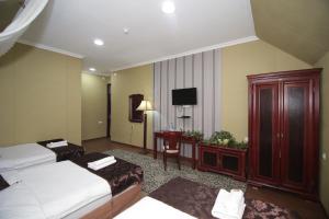 Postel nebo postele na pokoji v ubytování Khujand Deluxe Hotel
