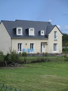 a large white house with a black roof at La maison de Mathilde in Saint-Jean-de-la-Motte