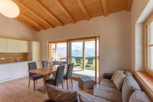 a kitchen and dining room with a couch and a table at Oberpfaffstallerhof in Collalbo