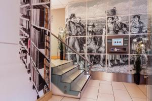 a staircase in a library with a mural at Stewart by Heeton Concept - Aparthotel Edinburgh in Edinburgh