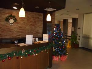 a christmas tree in front of a counter in a restaurant at F307 Studio Aspen Golf Resort Bansko in Bansko +45 photos