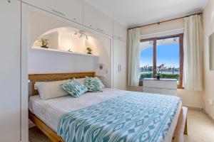 a bedroom with a large bed and a window at Apartment Carabela 2 in Alcudia +76 photos