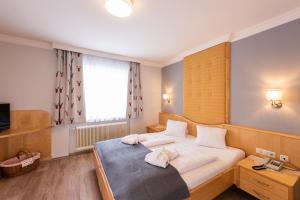 Postel nebo postele na pokoji v ubytování Genusshotel Almrausch