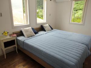 Voodi või voodid majutusasutuse Vacances a la mer Ishigaki toas
