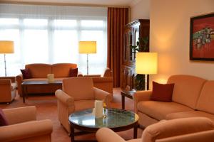 a living room with couches and chairs and a table at Hotel Anna in Badenweiler