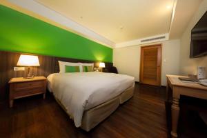 Letto o letti in una camera di Green World Triple Beds