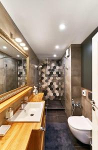 a bathroom with a sink and a toilet and a shower at Stylish and High-end Designer Apartments in City Center in Sofia