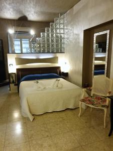 Un dormitorio con una gran cama blanca y una mesa en Casa Tua a Piazza del Popolo en Roma