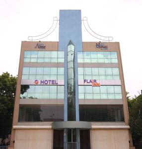 un edificio alto con un cartel de hotel en Hotel Flair Inn en Ahmedabad