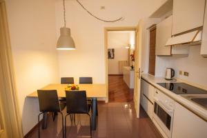 a kitchen with a table and chairs in a room at Italianflat - Via Mazzini in Verona