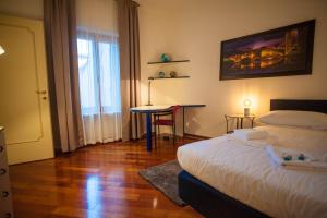 a bedroom with a bed and a table and a window at Italianflat - Via Mazzini in Verona