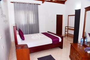 A bed or beds in a room at Cinnamon Holiday Inn