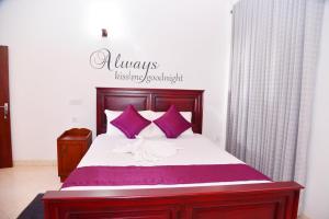 A bed or beds in a room at Cinnamon Holiday Inn