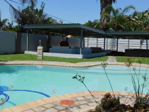 a swimming pool in a yard with a pavilion at Savannah Guest House in Polokwane