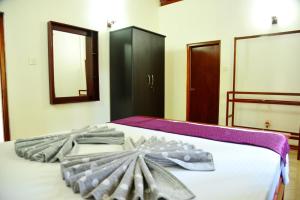A bed or beds in a room at Cinnamon Holiday Inn