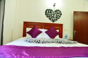 A bed or beds in a room at Cinnamon Holiday Inn
