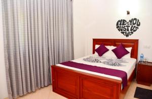 A bed or beds in a room at Cinnamon Holiday Inn