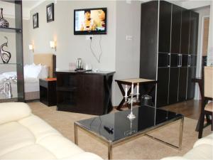 a living room with a couch and a tv on the wall at Park Hotel in Ulaanbaatar