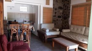 a living room with a couch and a table at Altos del Molle SF in San Francisco del Monte de Oro