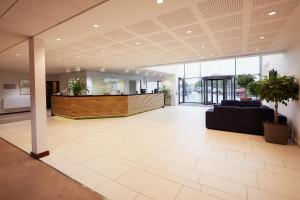 a lobby with a waiting area in a building at Warwick Conferences - Radcliffe in Coventry