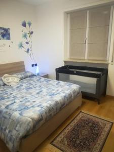 a bedroom with a bed and a dresser and a piano at Cà delle Rose in Rovereto