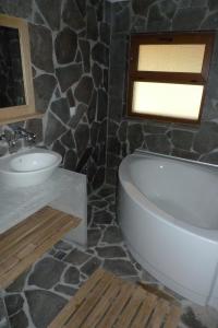 a bathroom with a sink and a toilet and a tub at Borislav's Farmhouse in Ogled
