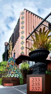 a fountain in front of a building with a building at Dhevi Bangkok Hotel in Bangkok