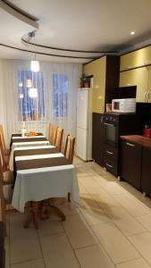 a kitchen with a table and chairs and a kitchen with a table and a kitchen at Krashanka in Tatariv