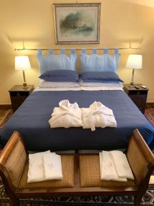 a bedroom with a bed with towels on it at Villa Albina in Rome