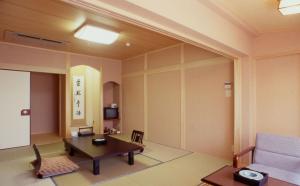 a living room with a table and a couch at Hitomaru Kadan in Akashi