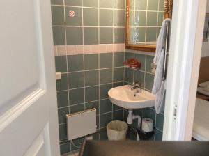 a small bathroom with a sink and a mirror at Kalkstenens Bed and Breakfast in Mörbylånga +19 photos