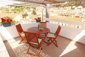 a table and chairs on a balcony with a view at Vila Maria Old Town Hvar in Hvar