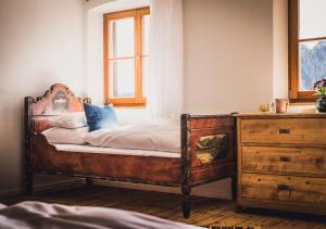 an old bed in a room with a dresser at Berghotel Altes Wallberghaus in Rottach-Egern
