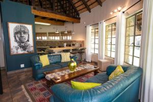 a living room with a blue couch and a table at Blyde River Wilderness Lodge in Hoedspruit