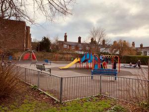 a park with a playground with slides and a slide at Tapestry Apartment in London