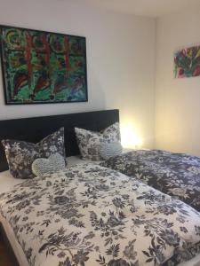 a bedroom with a bed with a black and white comforter at Am Bungert in Mayschoß