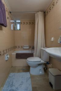 e bagno con servizi igienici, vasca e lavandino. di Cozy & Quiet Central Apartment a Kalamáta
