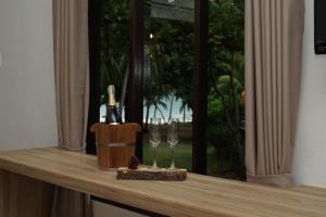 a counter with a bottle of wine and two glasses at Aquavana Haad Rin Resort in Haad Rin