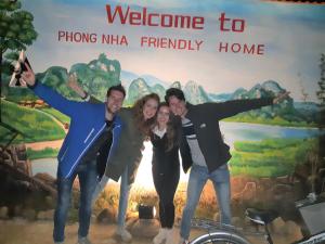 a group of people standing in front of a sign at Phong Nha Friendly Home in Phong Nha