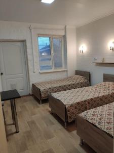 Säng eller sängar i ett rum på Yuzhny Briz Guest House