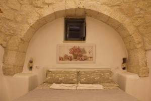 Postel nebo postele na pokoji v ubytování Masseria Trulli sull'Aia