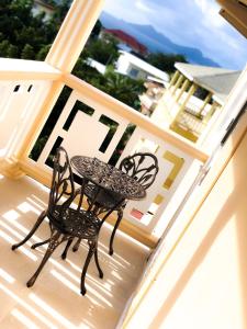 a table and chair sitting on a balcony at Calliandras Apartment Complex in Kingstown