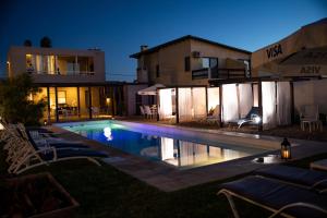a swimming pool in front of a house at night at Cara Colomba in La Paloma