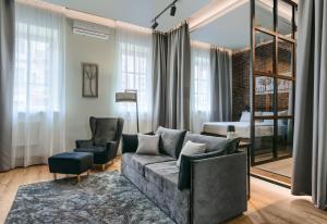 a living room with a couch and two chairs and a bedroom at Number 21 by DBI in Kyiv
