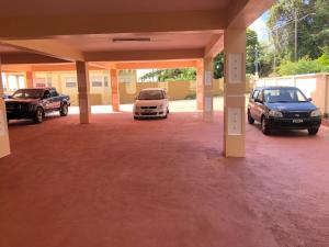 a garage with two cars parked in it at Calliandras Apartment Complex in Kingstown