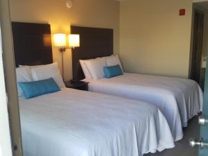 two beds sitting next to each other in a hotel room at The Dunes Rehoboth Beach in Dewey Beach